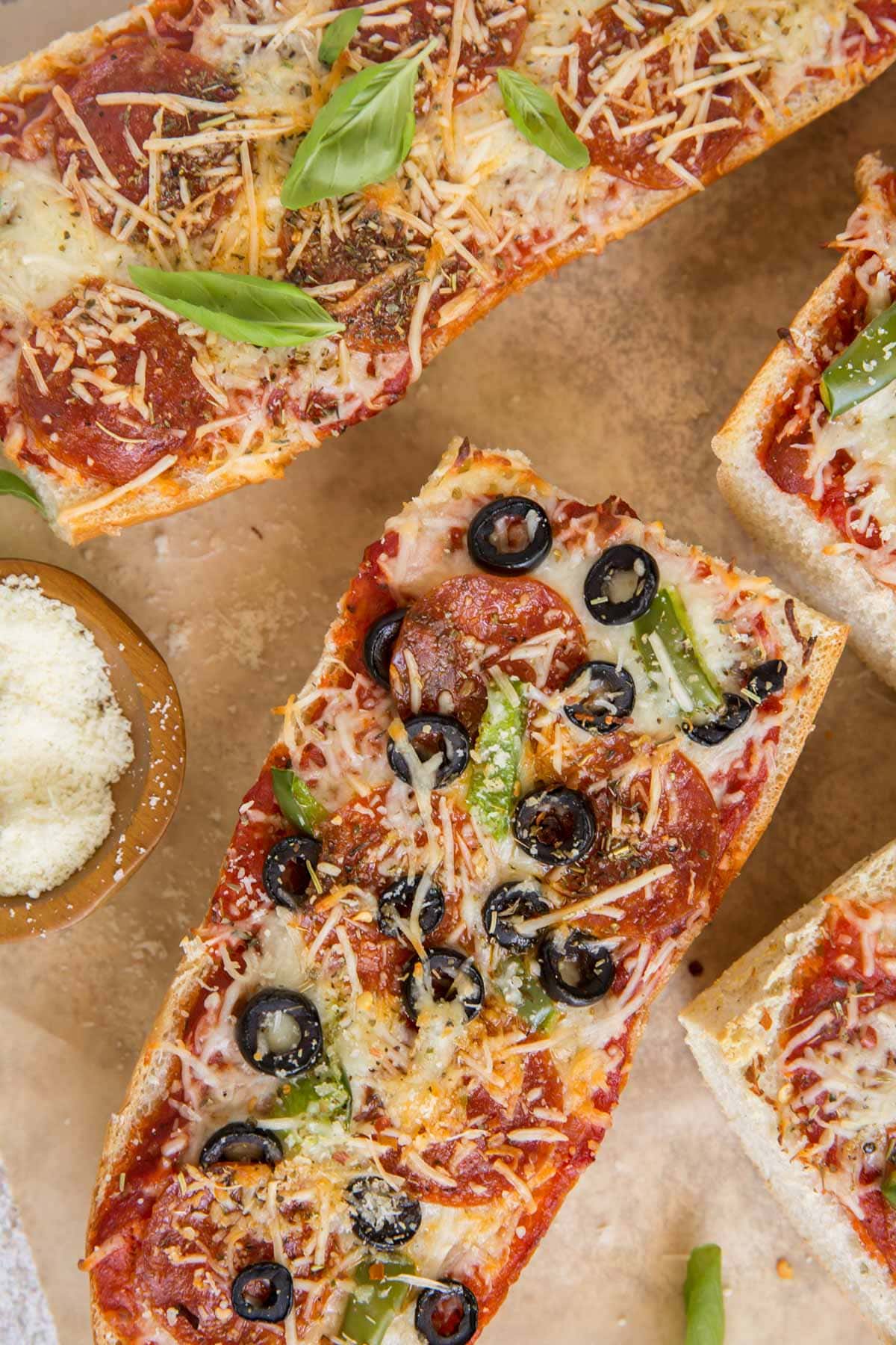 pizza bread with olives and cheese, brown parchment paper