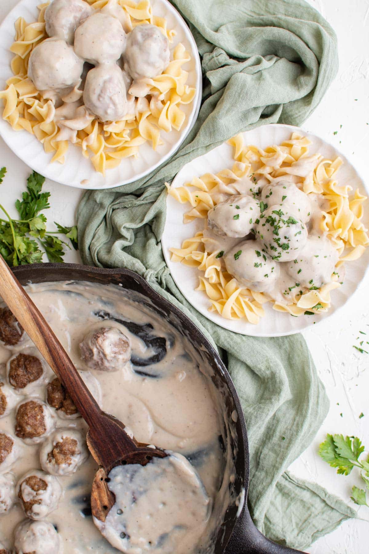 skillet, wooden spoon, meatballs, noodles, gravy