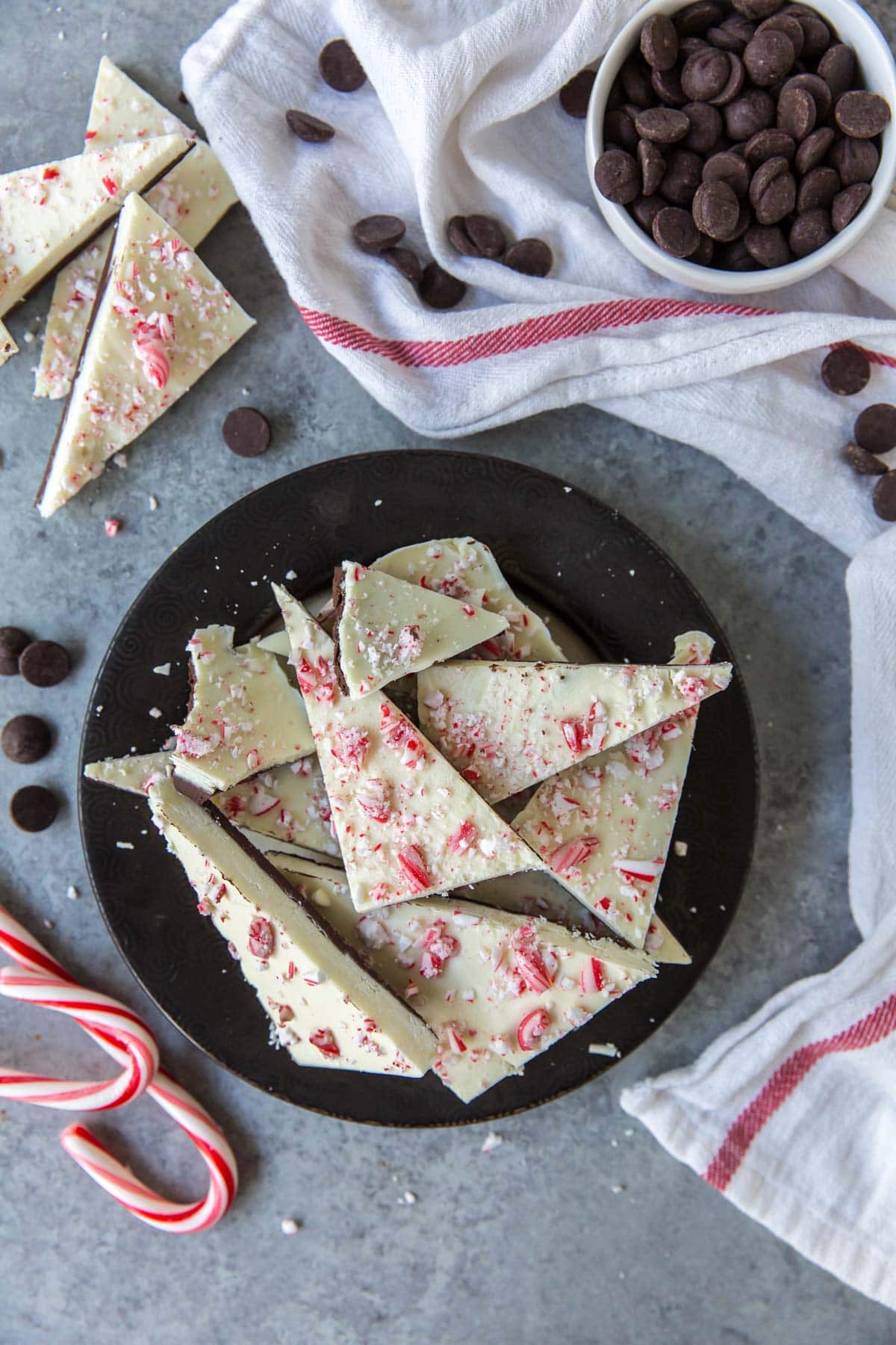 peppermint bark, candy canes, black plate, white towel, chocolate chipe