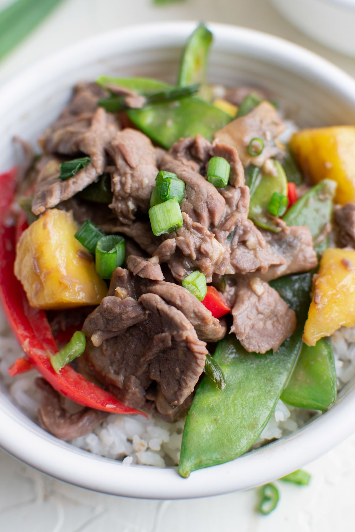 white bowl, stir fry vegetables, pineapple, beef