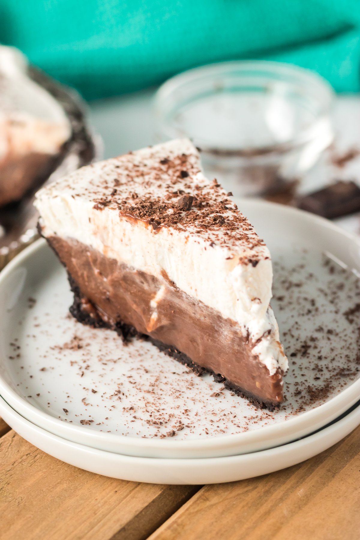 slice of chocolate cream pie on a stack of white plates