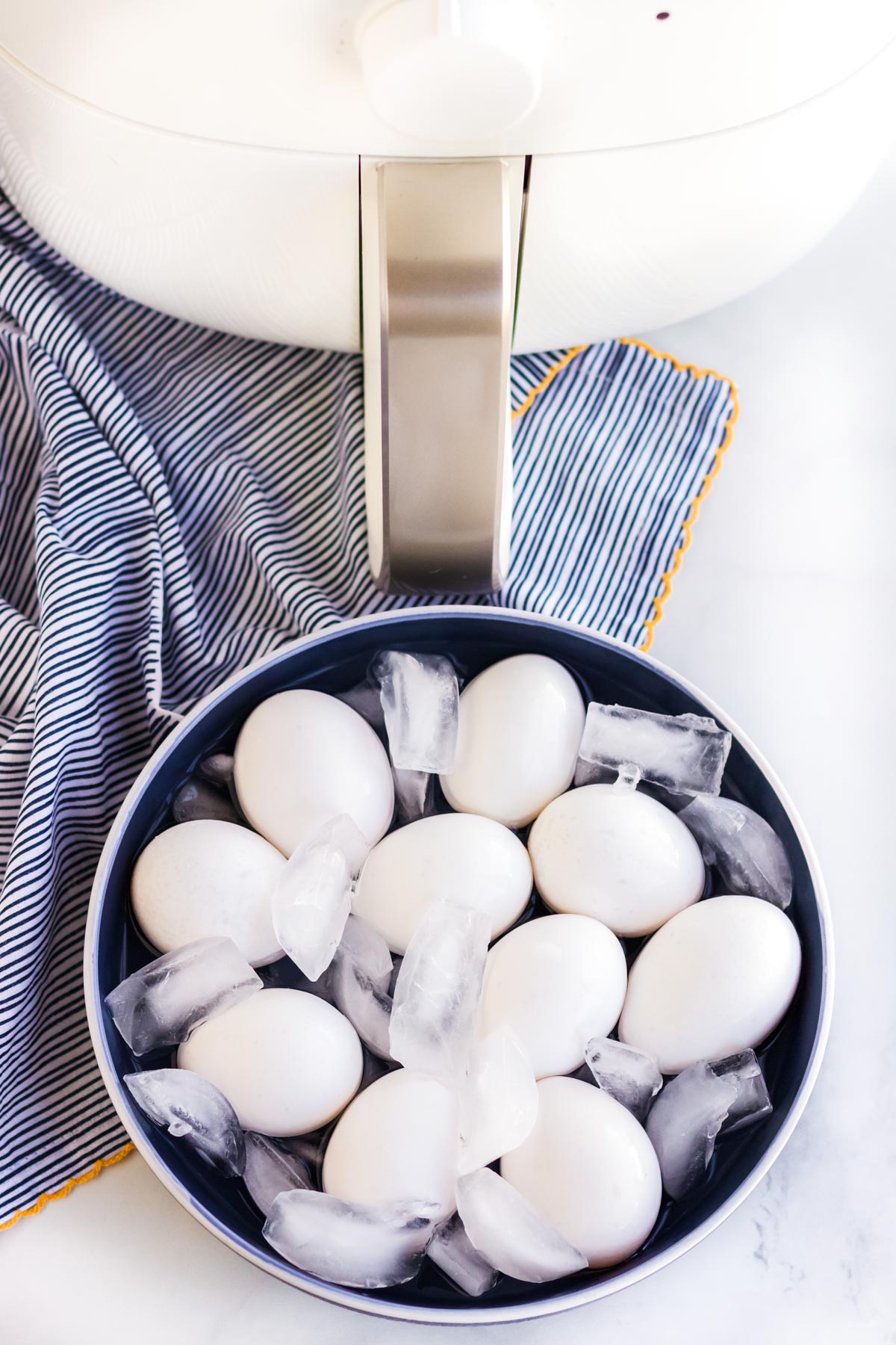 air fryer, eggs and ice water bath in a dish, blue napkin