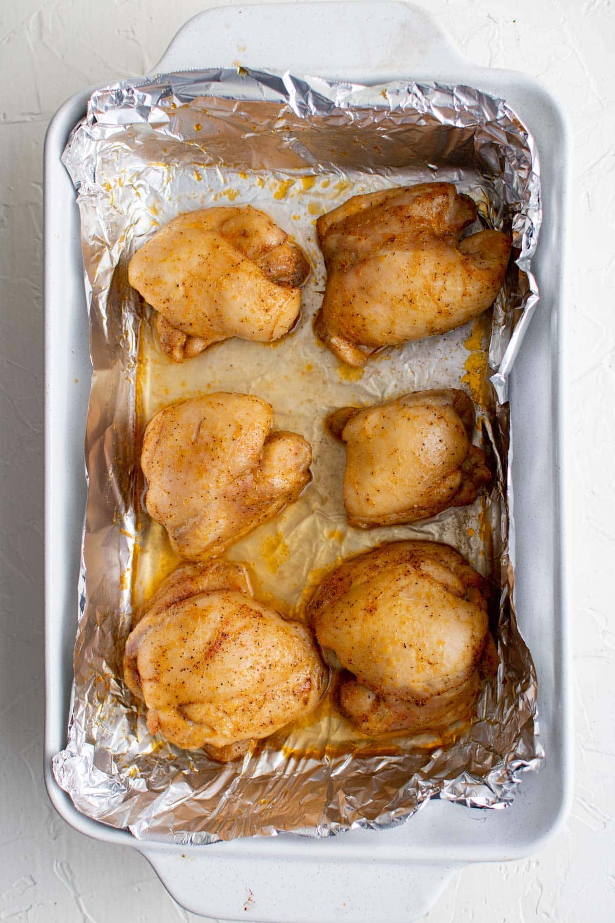 roasted chicken thighs bakeng dish with foil