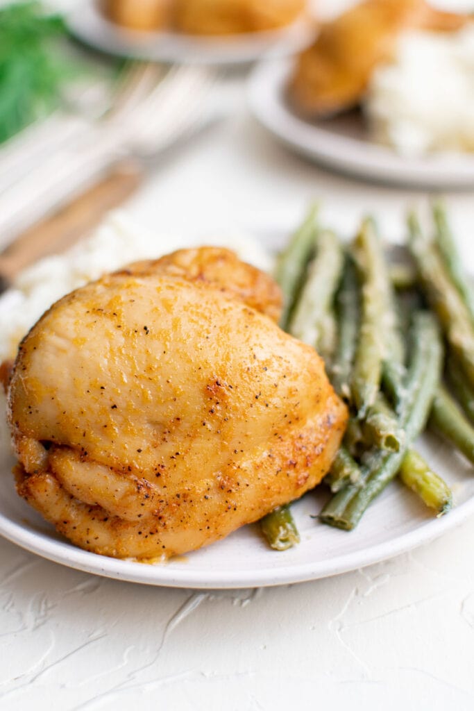 boneless chicken thigh, green beans, white plates