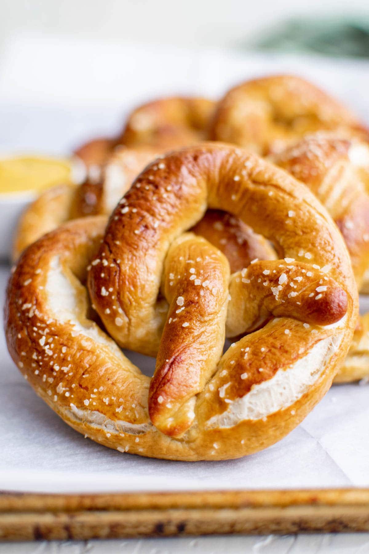 soft pretzels baked with salt, wood cutting board, parchment paper