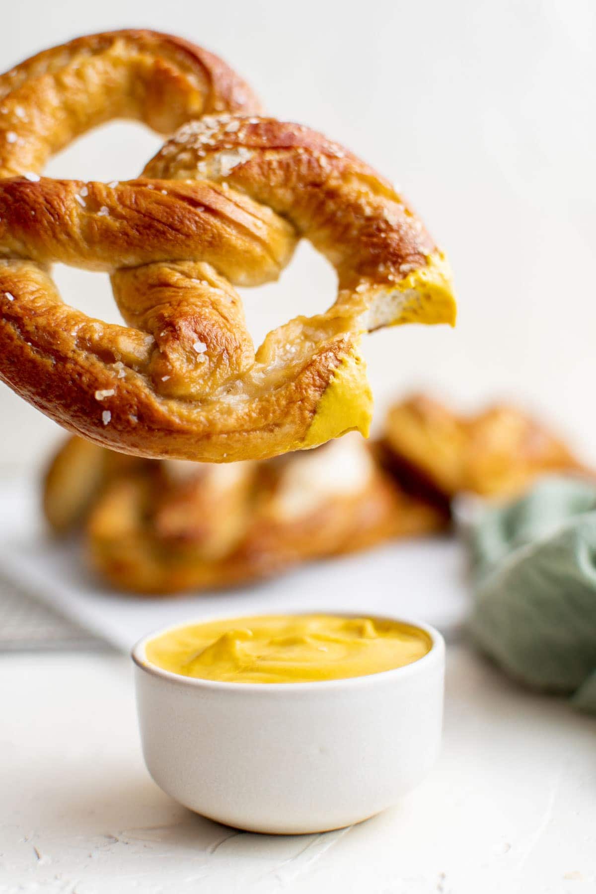soft pretzel dipped in mustard