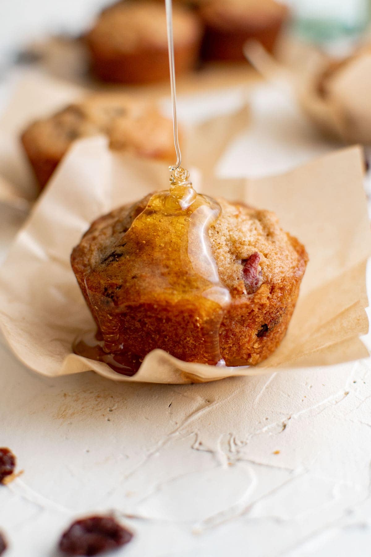 carrot cake muffins with honey drizzle, brown parchment paper, raisins