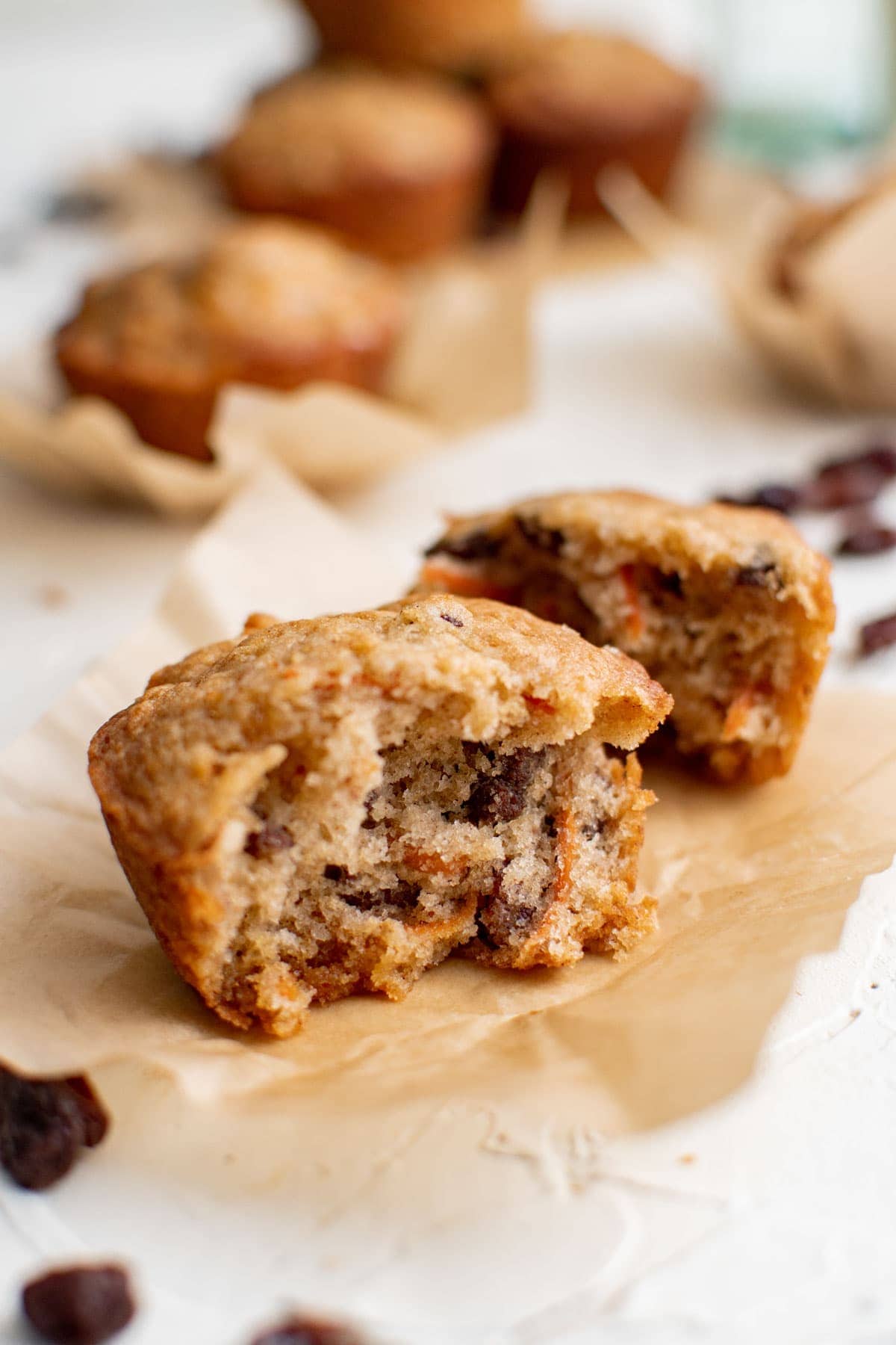 carrot muffin, split in half, raisins, brown parchment paper