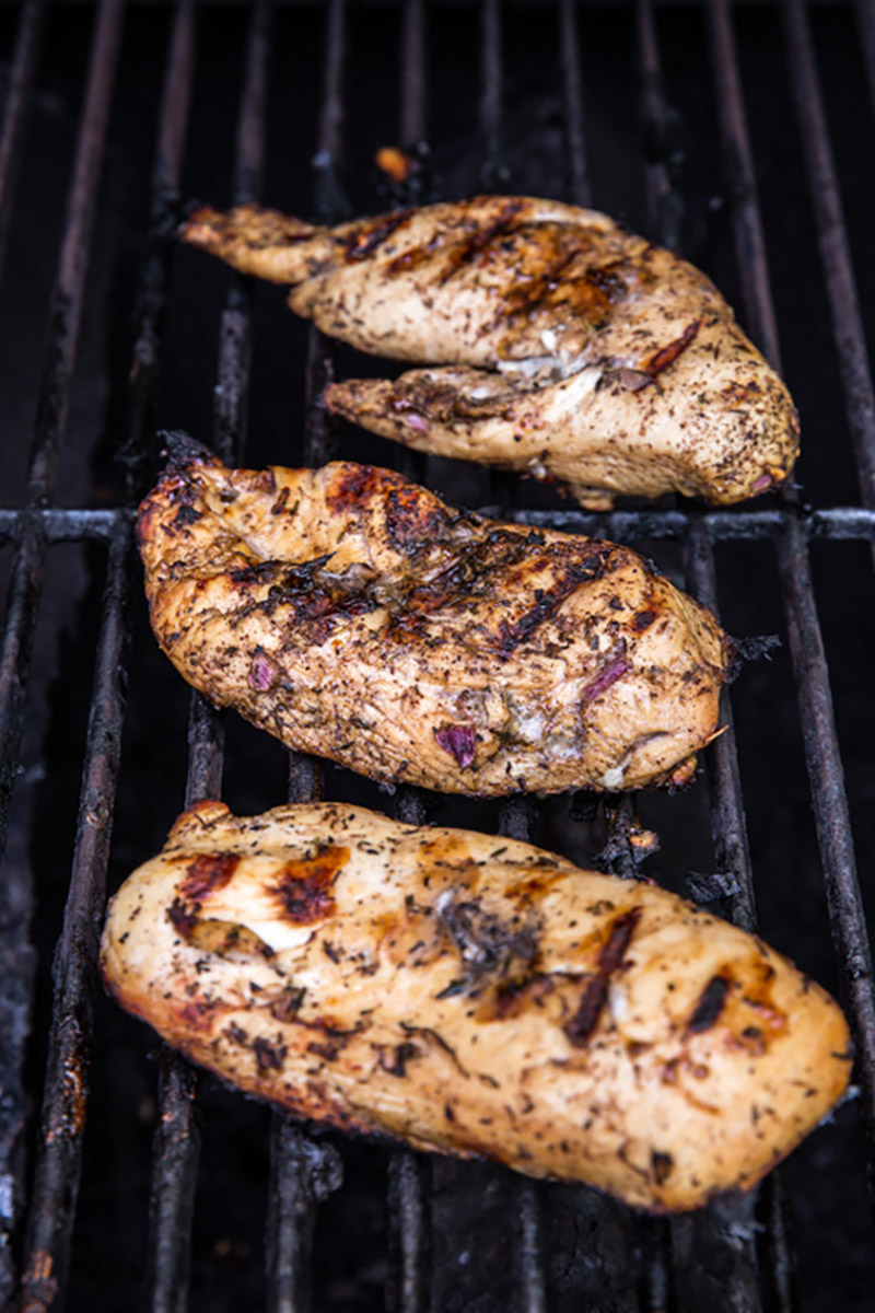 chicken breasts on a grill with grill marks