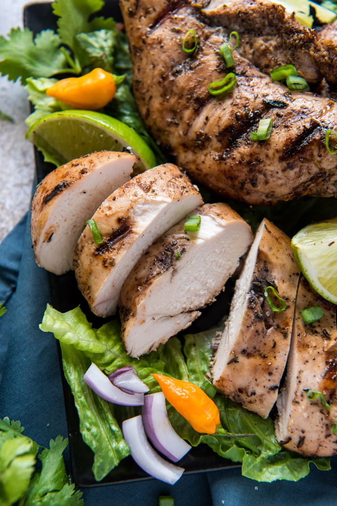 sliced jerk chiken on lettuce