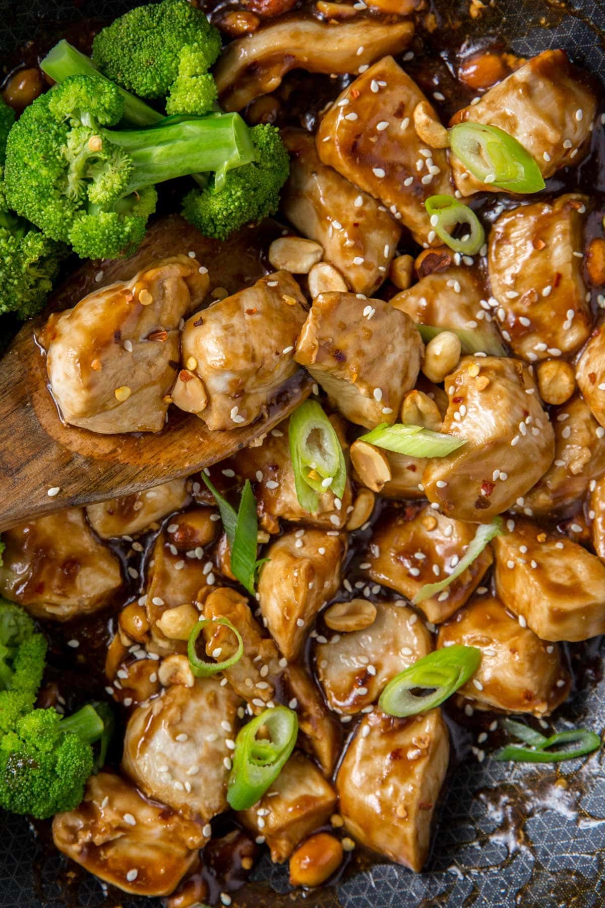 chicken with kung pao sauce, broccoli, black wok, green onions