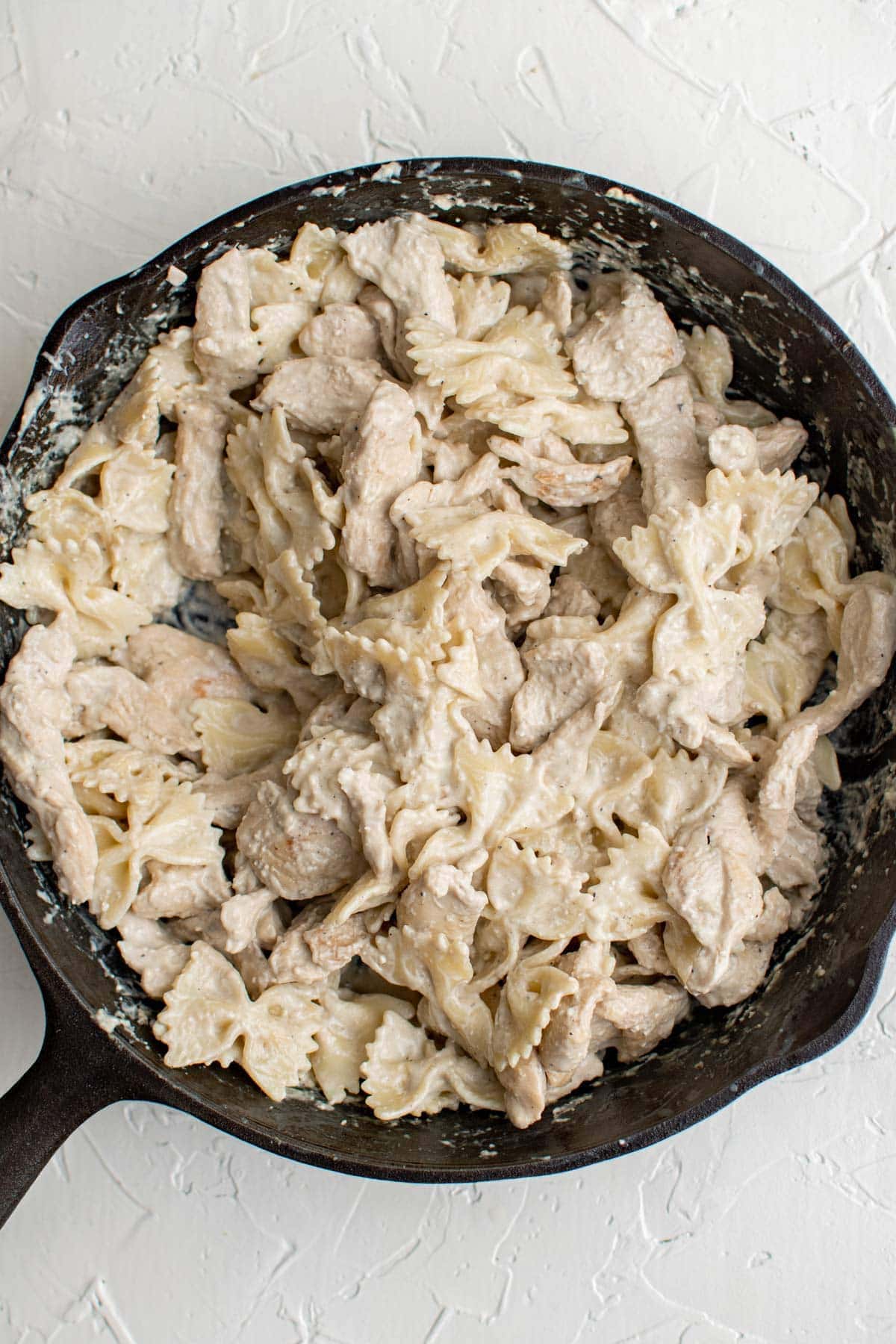 chicken and pasta in creamy sauce, cast iron skillet