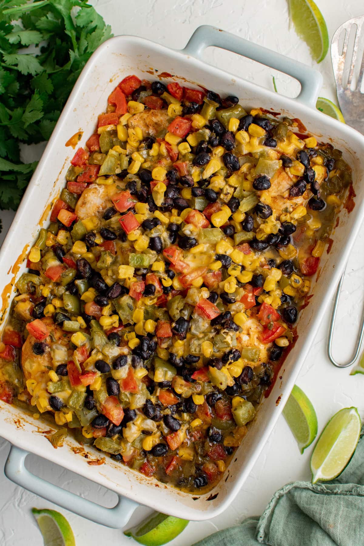 southwest chicken bake in a white casserole dish, cilantro