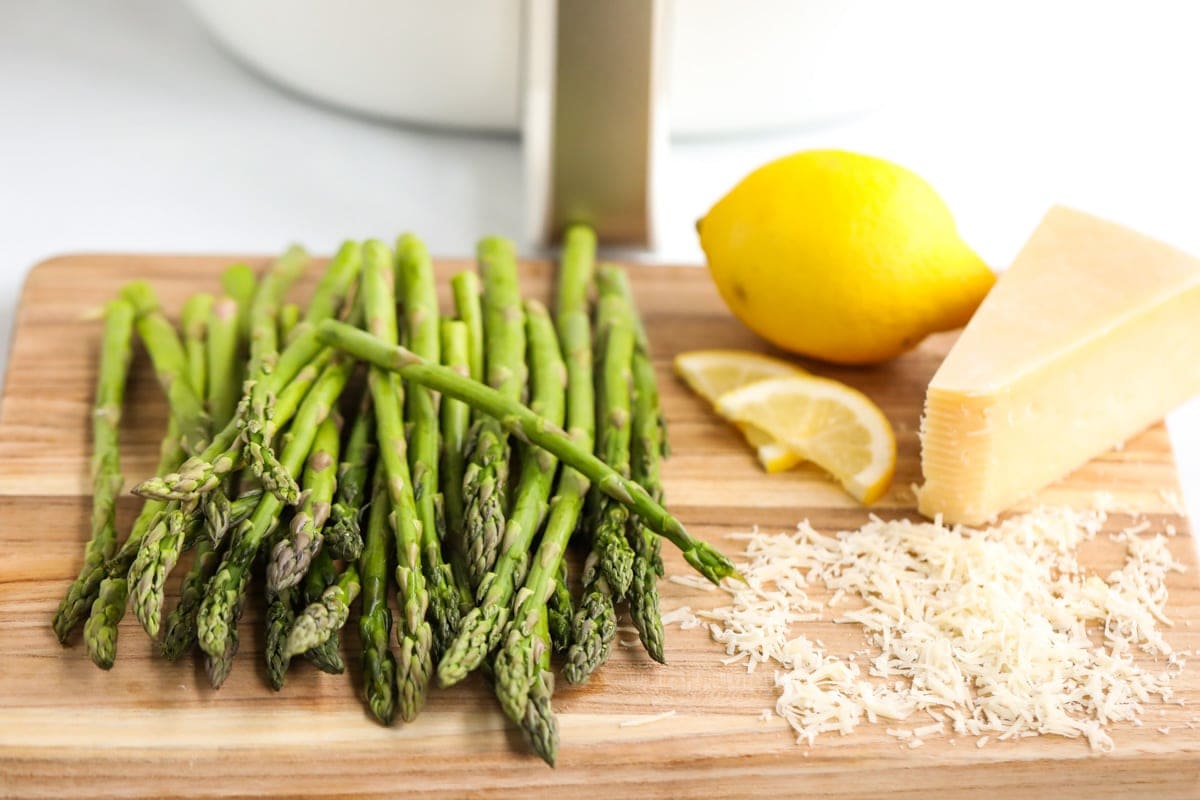 wood cutting board, lemon, parmesan cheese, asparagus