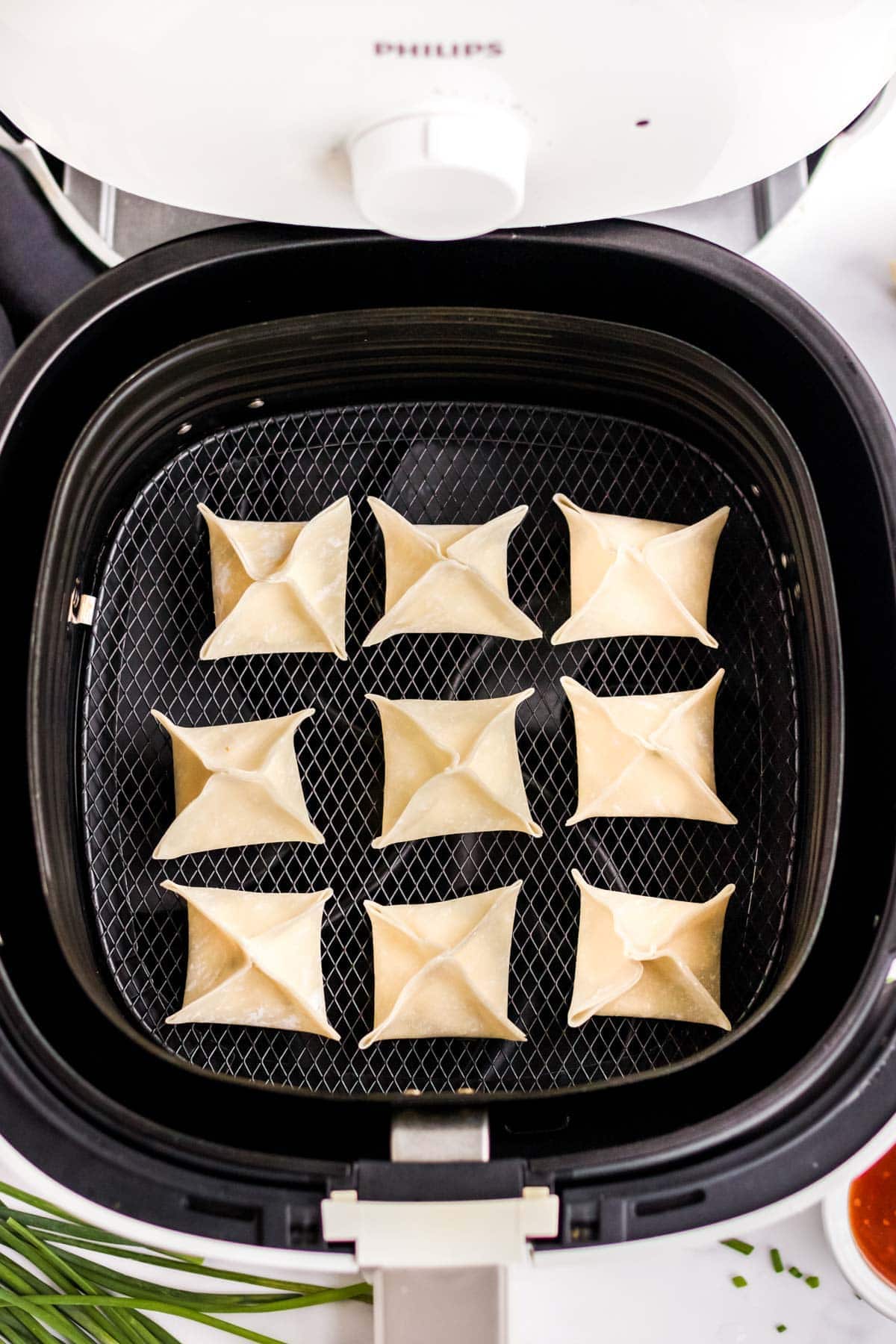 uncooked wontons in air fryer basket