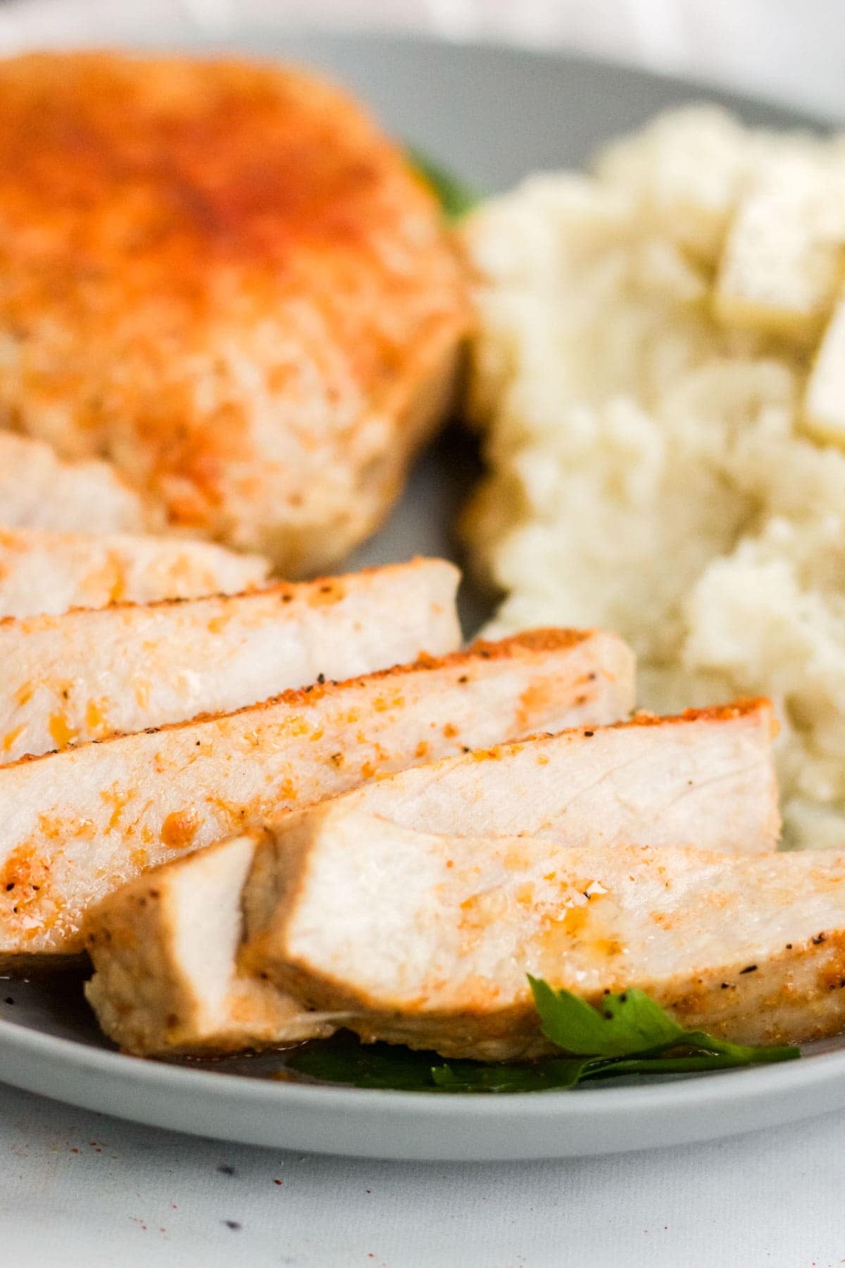 pork chop slices, mashed potatoes on a plate