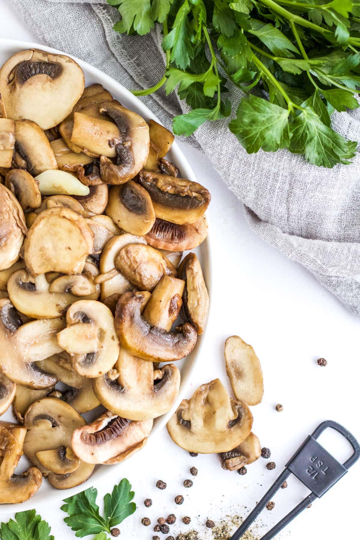 An overhead image of sauteed mushrooms on a plate.