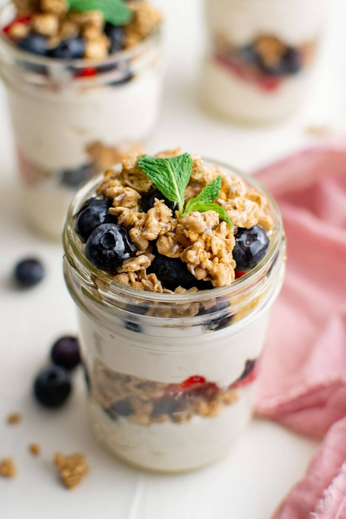 yogurt parfaits in glass jars, pink napkin