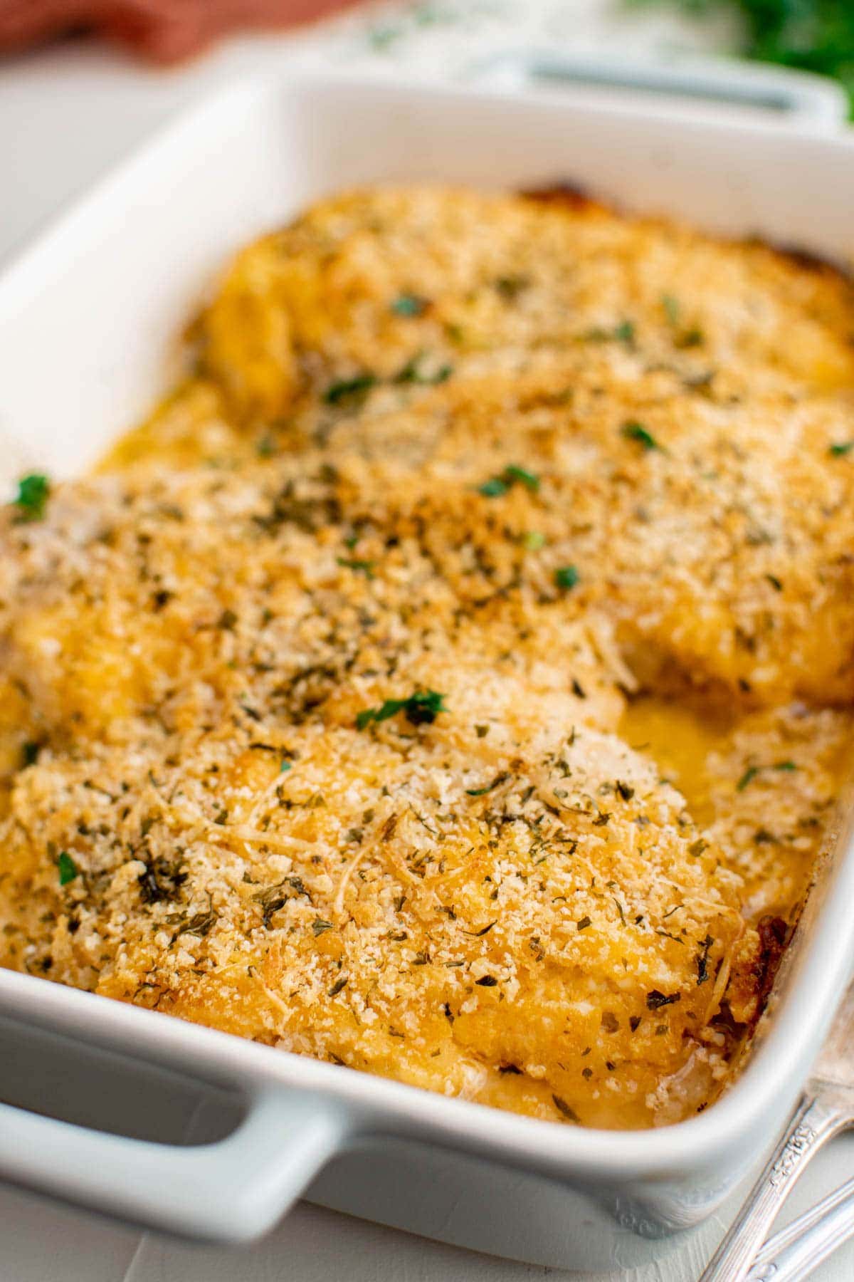 close up of chicken breasts with breadcrumbs and parsley