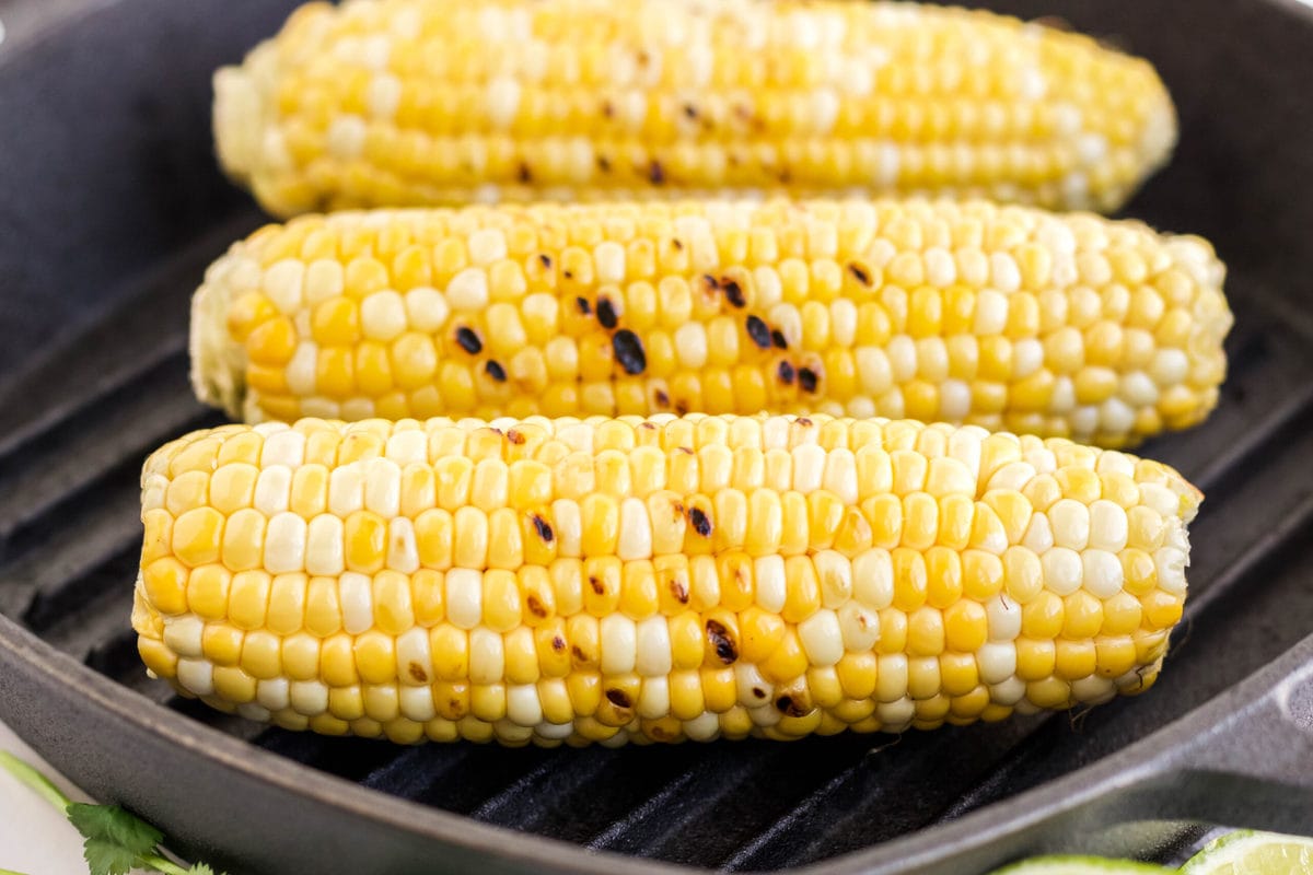corn on the cob sitting on a grill pan