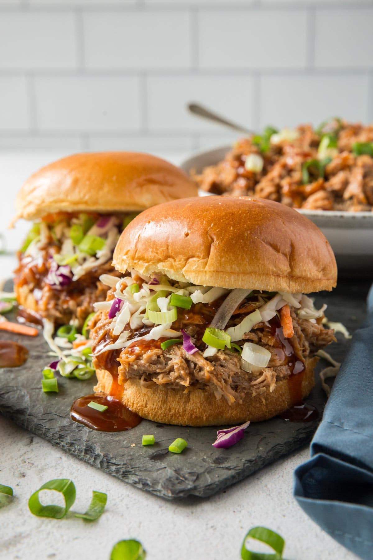 bbq pulled pork sandwiches on a slate board