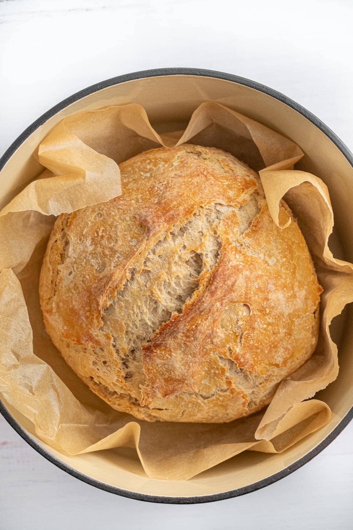 loaf of sourdough bread, parchment paper, dutch oven