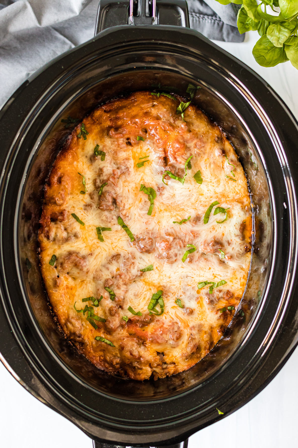 overhead shot of cheesy lasagna in slow cooker