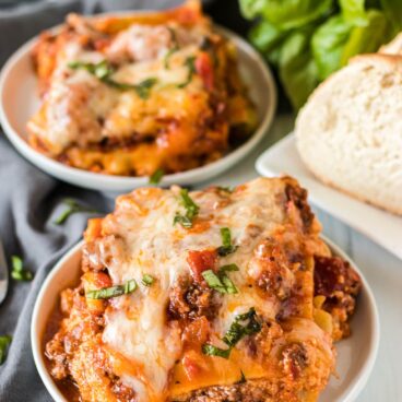 two servings of lasagna on white plates