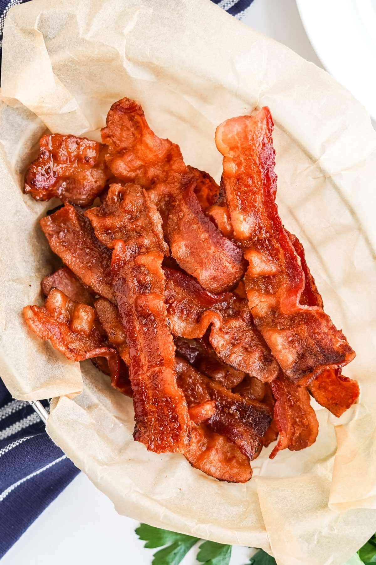 cooked, crispy bacon on a parchment lined plate