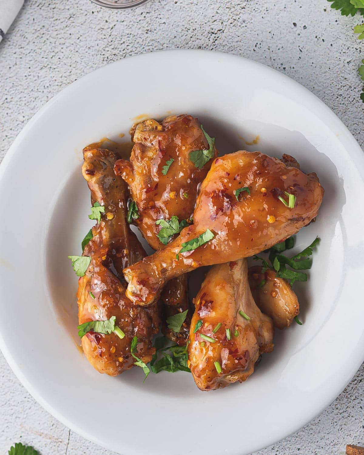 Glazed Drumsticks Served On a White Plate