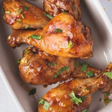 Air Fryer Chicken Drumsticks served on a white pan