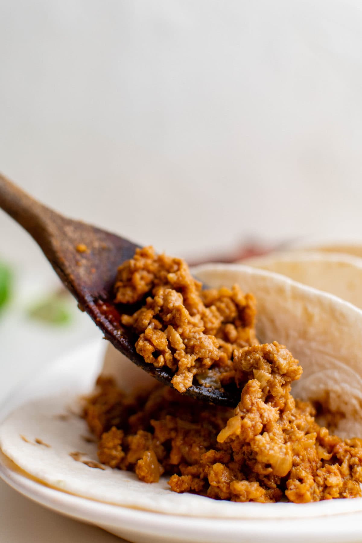 taco ground turkey, wooden spoon, flour tortilla