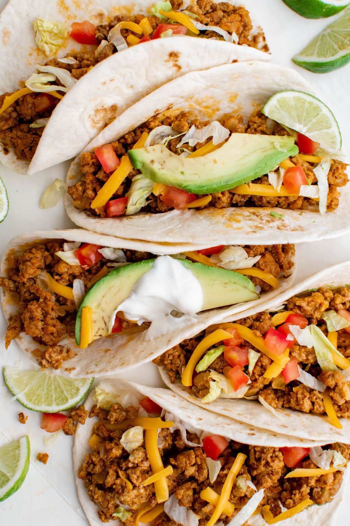 flour tortillas stuffed with ground turkey, cheese, lettuce, tomatoes, limes