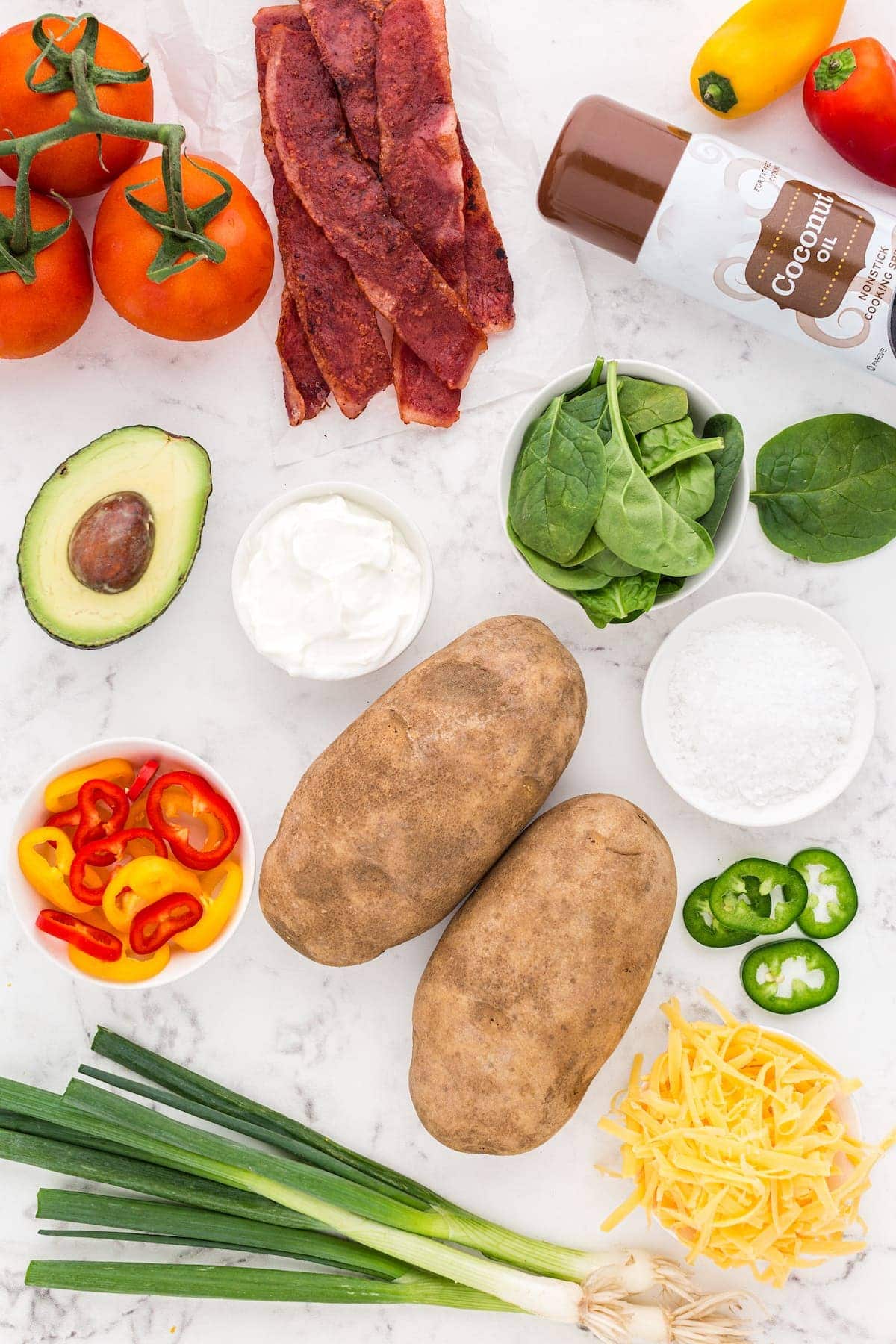 Ingredients for Irish Nachos including potatoes, bacon, tomatoes, peppers, cheese, and avocado.