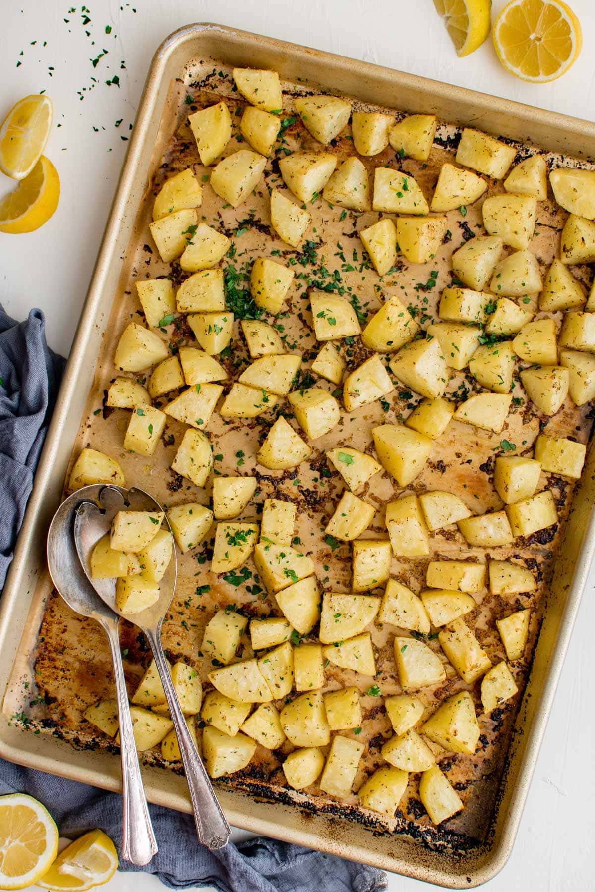 baking sheet, parchment paper, potatoes, lemons, parsley