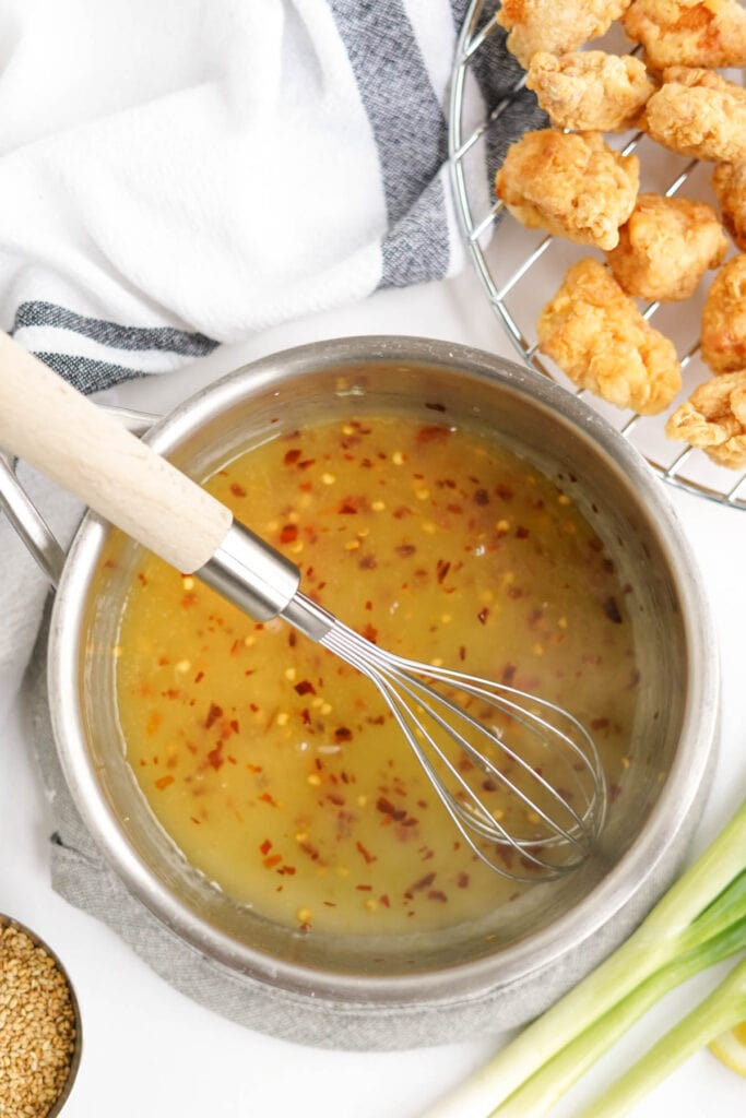 lemon sauce in a pot with a whisk