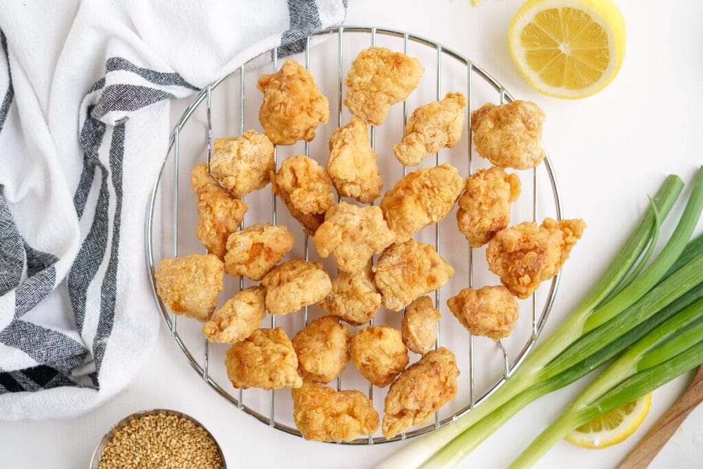 crispy fried pieces of chicken sitting on a wire rack