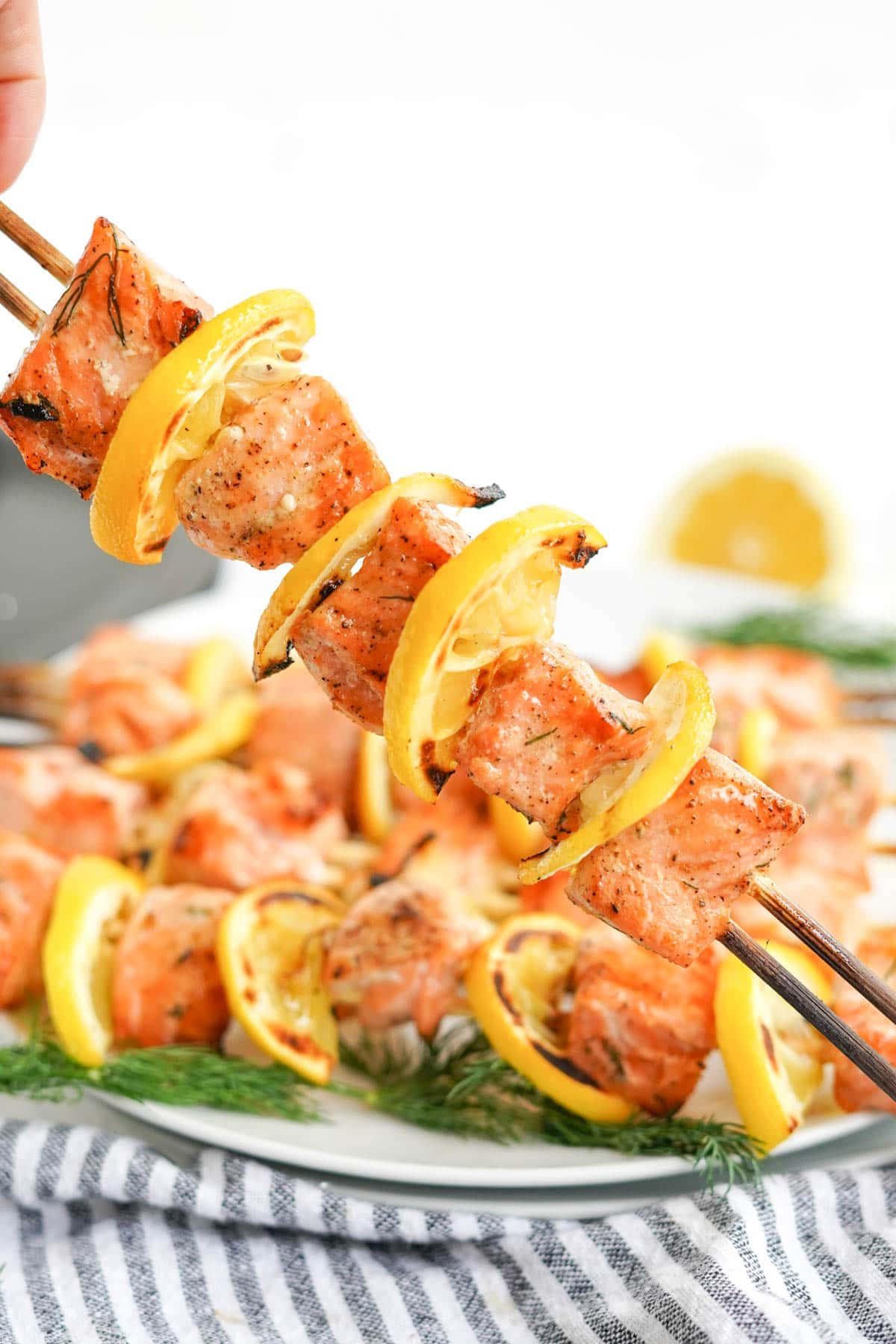 grilled salmon kabobs on a white plate