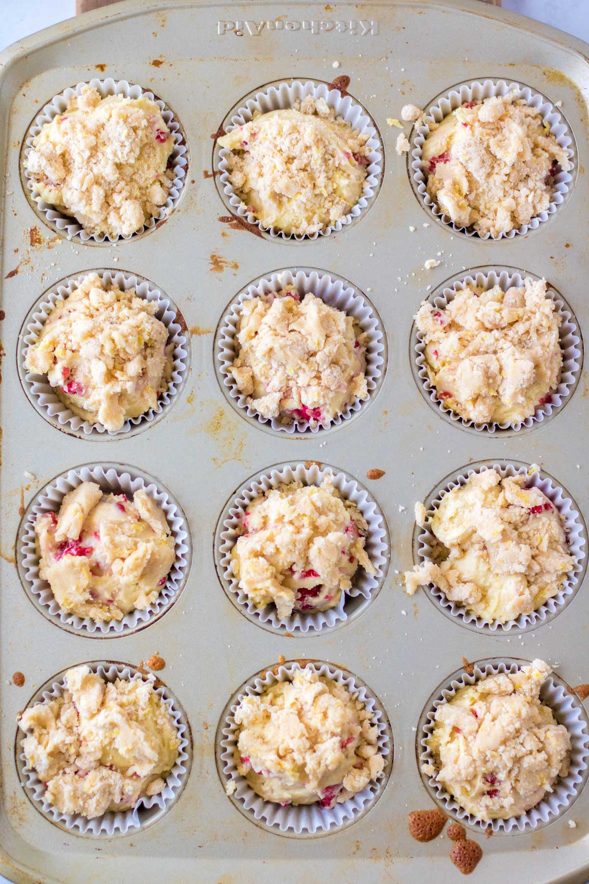 raspberry muffin batter in a muffin pan