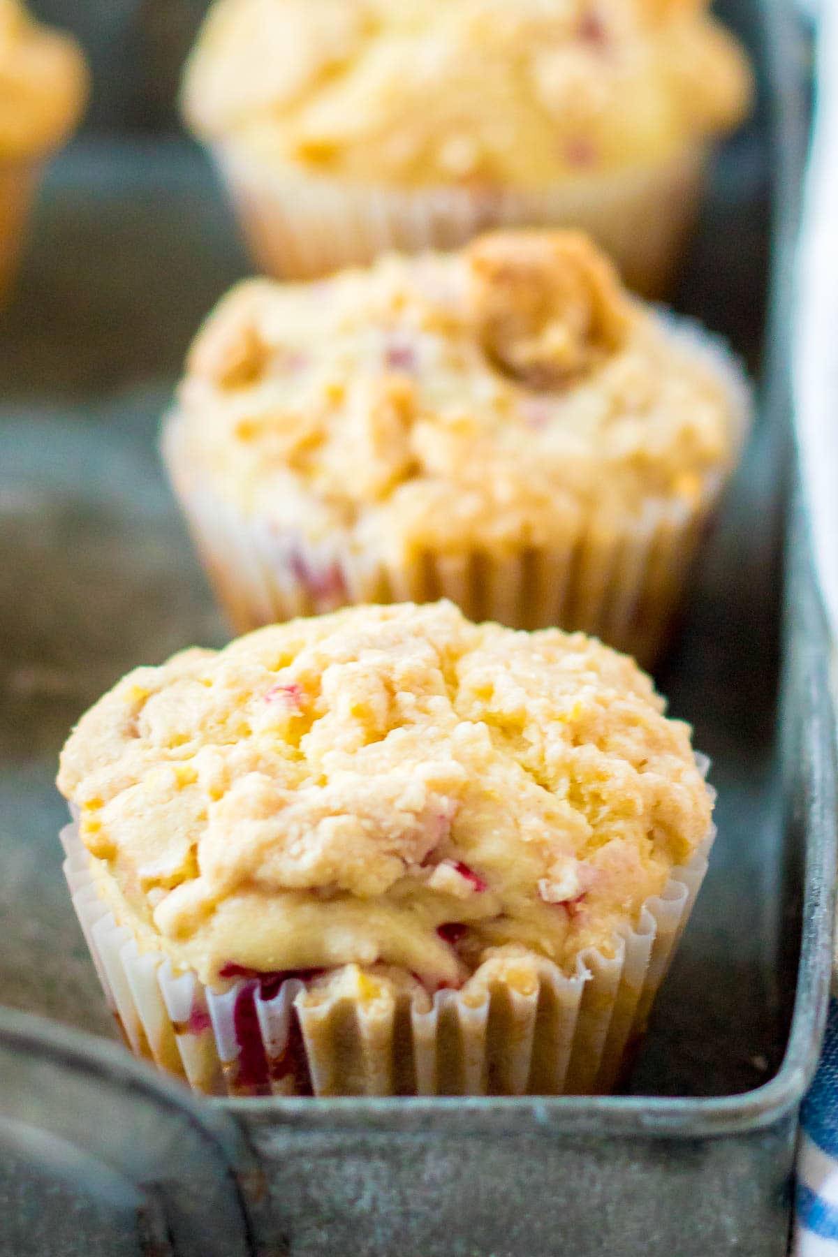lemon raspberry muffins with crumble topping in a metal pan