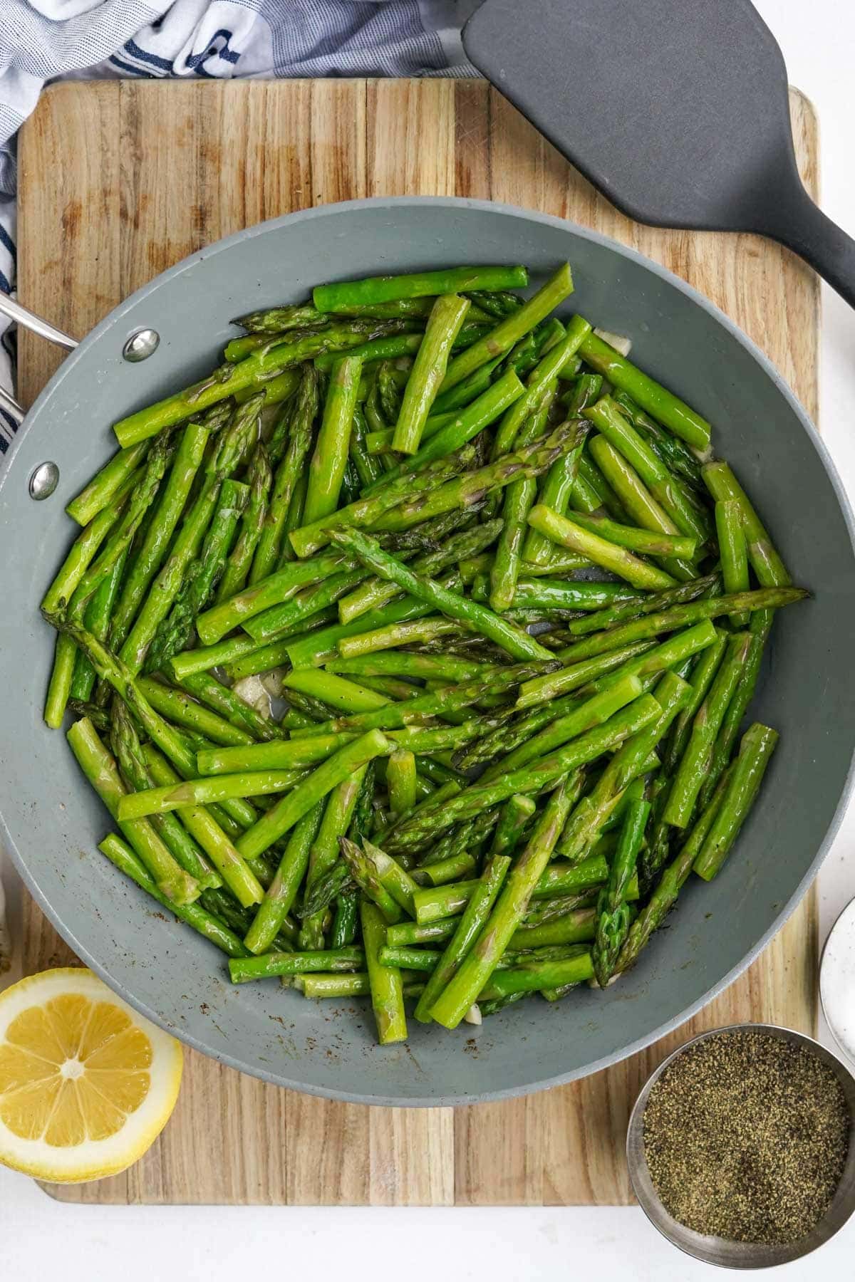 large skillet with sauteed asparagus