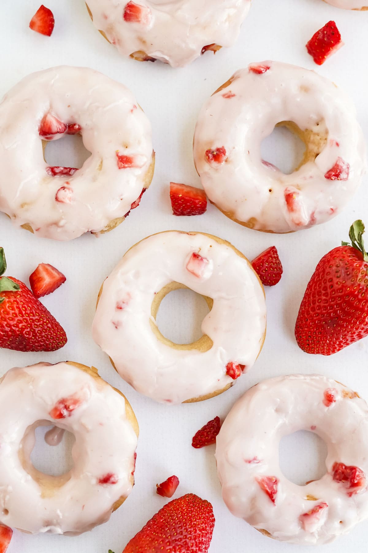 overhead image of strawberry doughnuts with glaze