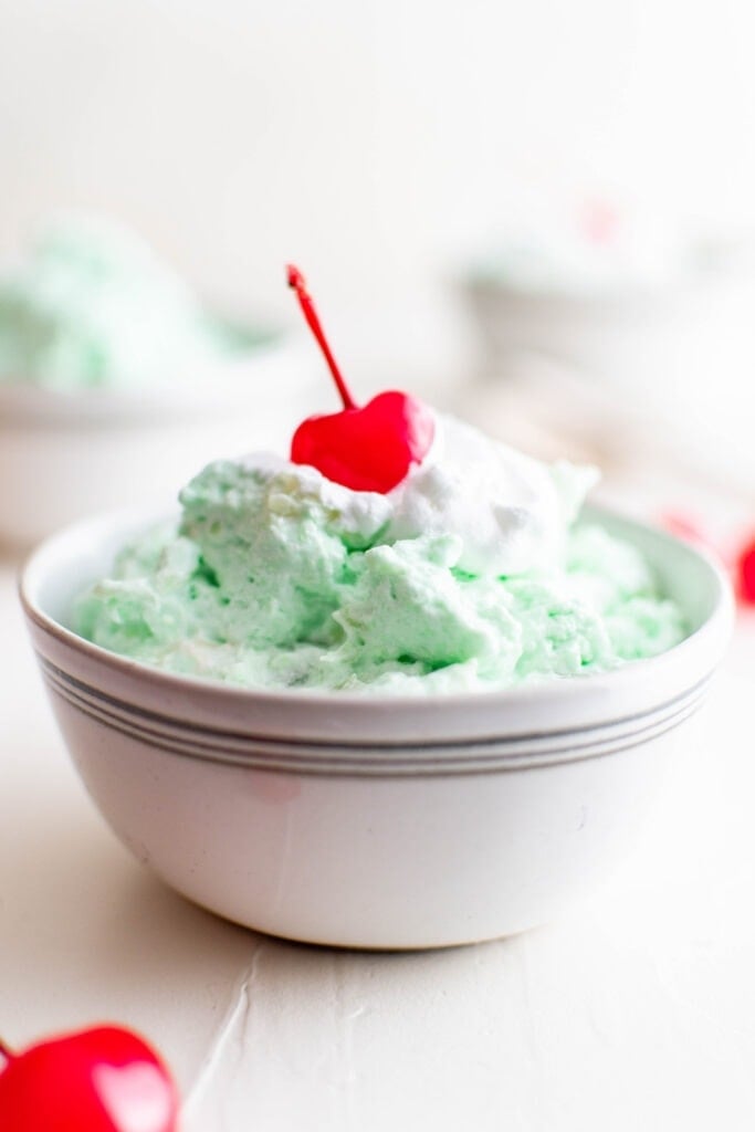 green jello, creamy salad, white dish