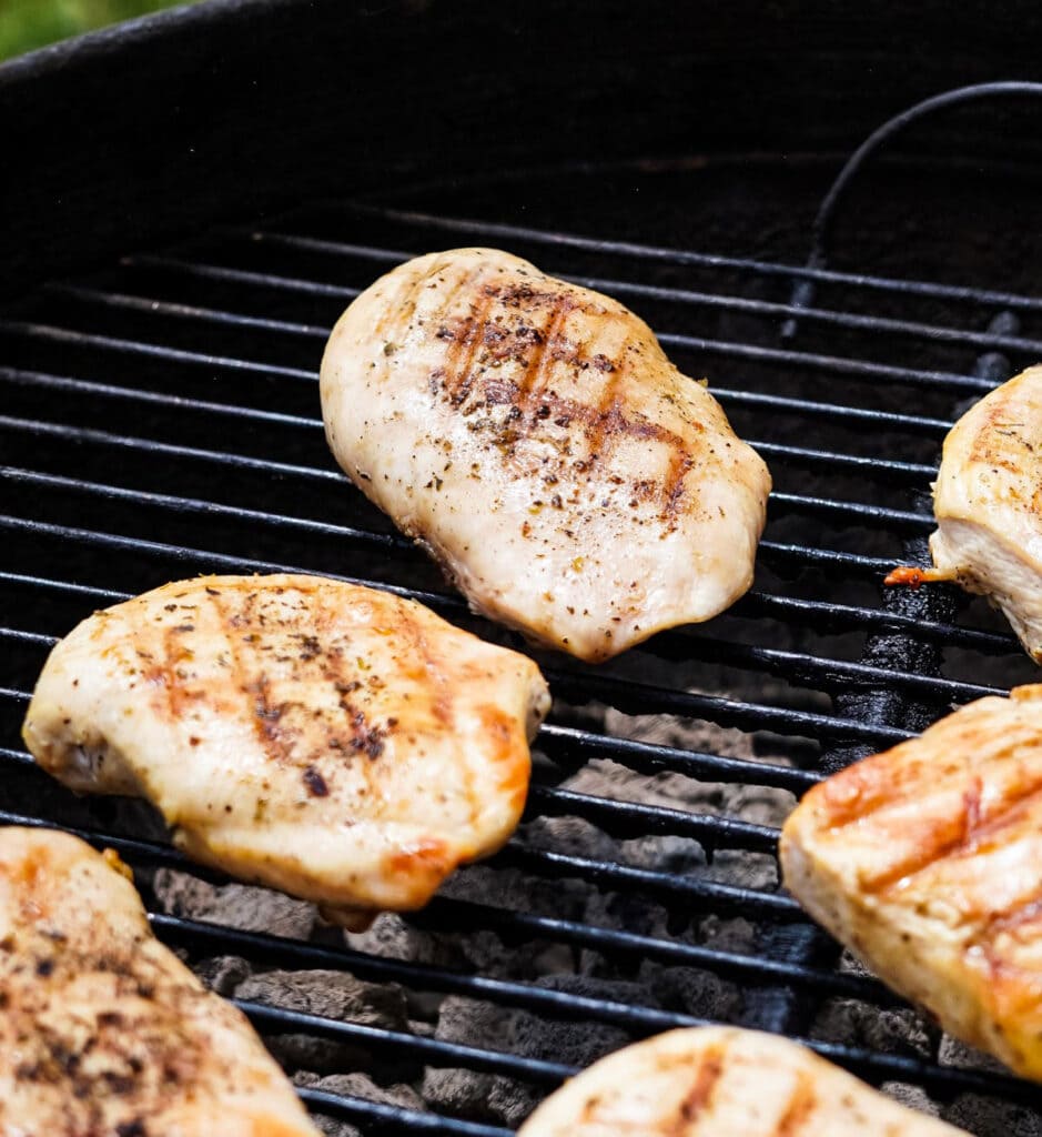 chicken breasts with char marks on a grill