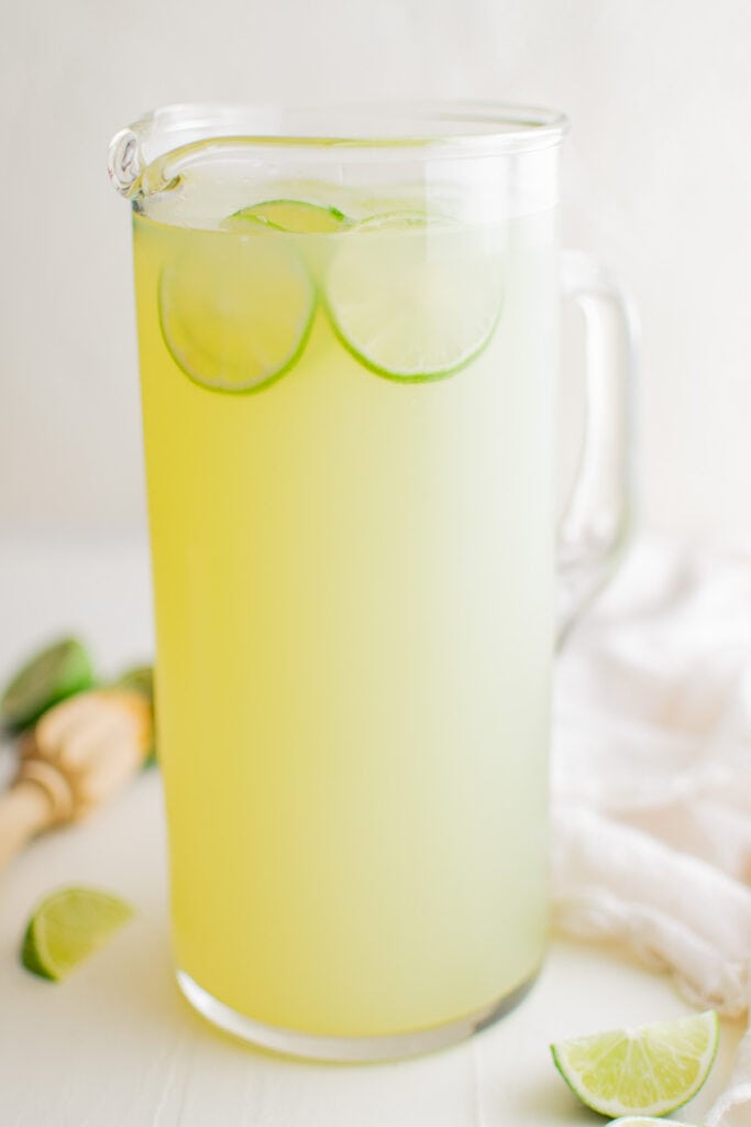 pitcher of limeade with sliced limes