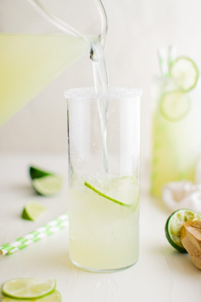 pouring limeade into a glass