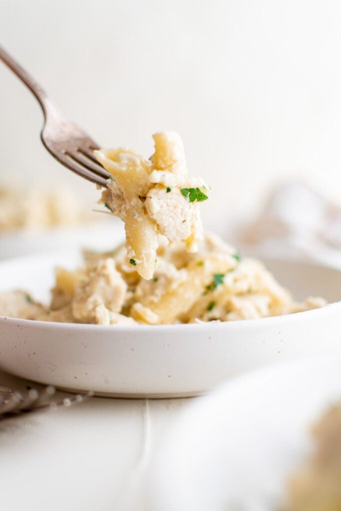 fork, bowl of pasta alfredo with chicken