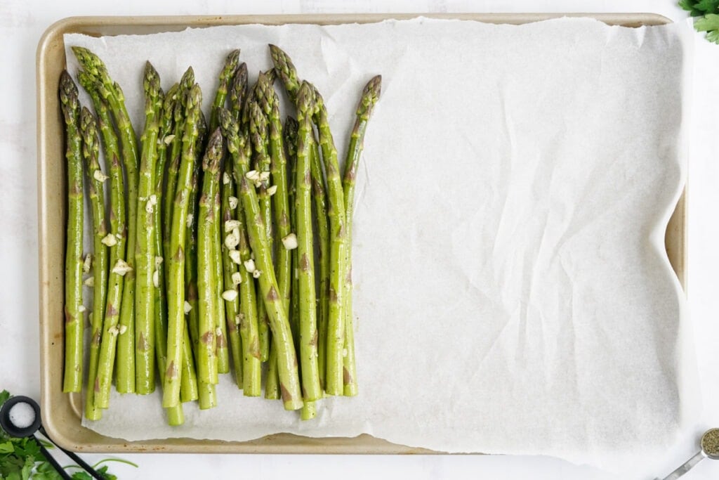 asparagus on a parchment paper lined sheet pan