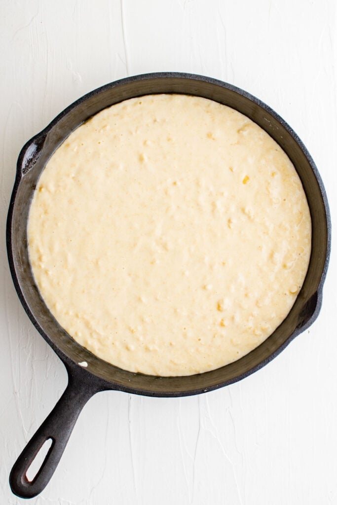 cornbread batter in a cast iron skillet