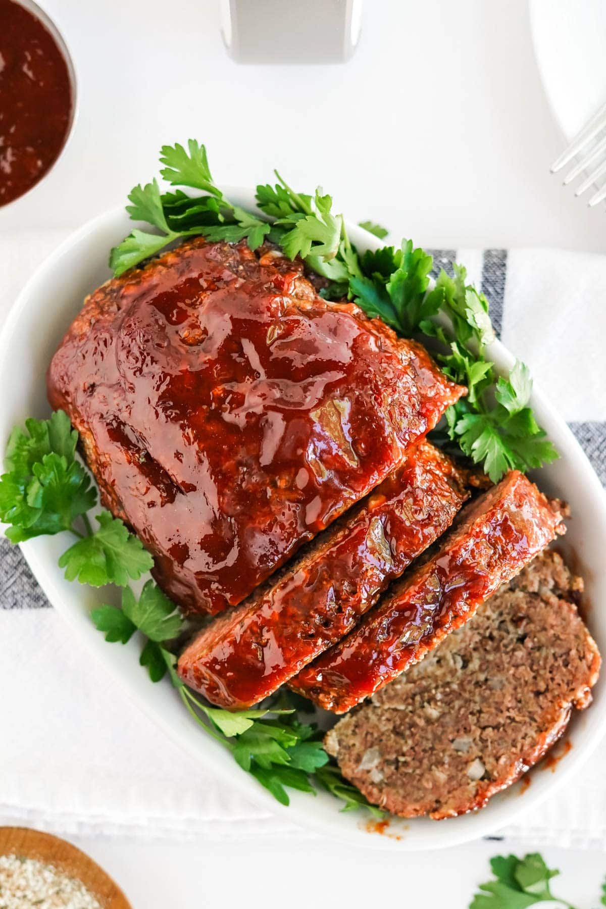 meatloaf on a white platter with glaze 